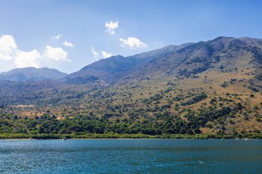 Lake Kournas on Crete and the mountains behind it clipart