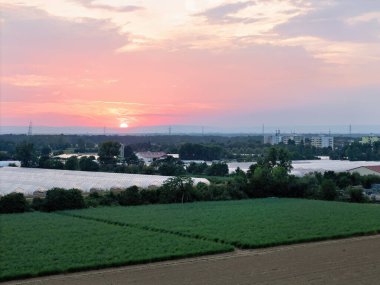 Weiterstadt with fields and red sunset in summer, drone shot clipart