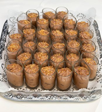 Küçük bardaklarda gümüş tabakta çikolatalı mus.