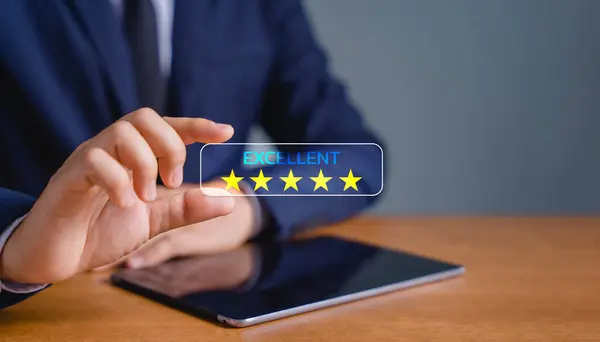 Business people are holding the virtual screen on the star icon to show satisfaction with service. Customer service and Satisfaction concept. rating very impressed.