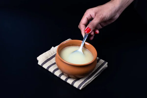 Pure Cow Ghee Ceramic Bowl Black Background Ghee Spoon Hand — Stock Photo, Image