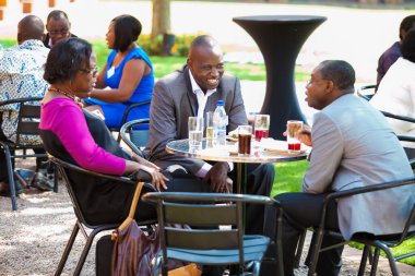 Johannesburg, South Africa - March 23, 2013: Mature students networking on college campus