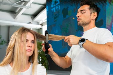 Cape Town, Güney Afrika - 15 Kasım 2022: Kuaförde genç bayan modeller üzerinde çalışan profesyonel stilist