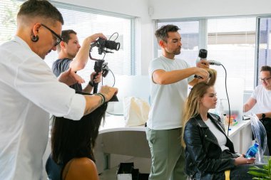 Cape Town, Güney Afrika - 15 Kasım 2022: Kuaförde genç bayan modeller üzerinde çalışan profesyonel stilist