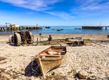 Port Nolloth, South Africa - March 16, 2024: Small fishing rowboat on a beach in coastal town clipart
