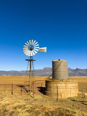 Windmill wind pump in the Namaqualand farming region of South Africa clipart