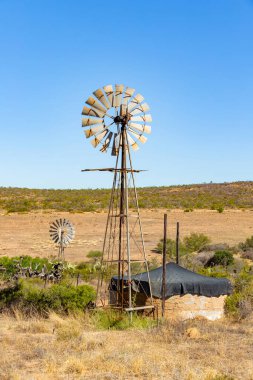 Farming windmill wind pump in the Namaqualand region of South Africa clipart