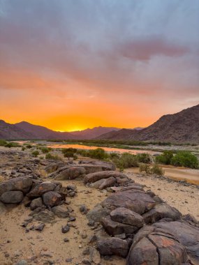 View of the Orange River at sunset from Tatasberg campsite in the Richtersveld National Park, arid area of South Africa clipart