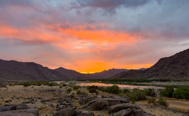 View of the Orange River at sunset from Tatasberg campsite in the Richtersveld National Park, arid area of South Africa clipart