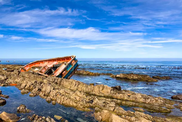 stock image Shipwrecked diamond mining vessel on rocky shoreline in small West Coast town of Port Nolloth, South Africa