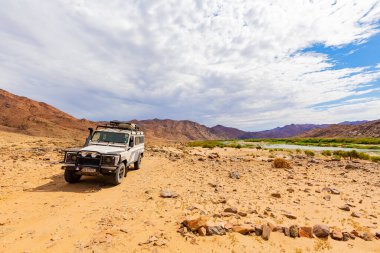 Richtersveld, Güney Afrika - 12 Mart 2024: Eski Land Rover Defender kurak bölgedeki bir kamp alanına park etti