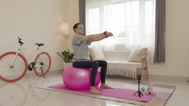 Woman Sitting Exercise Ball Practicing Overhead Tricep Extension Dumbbells While — Vídeos de Stock