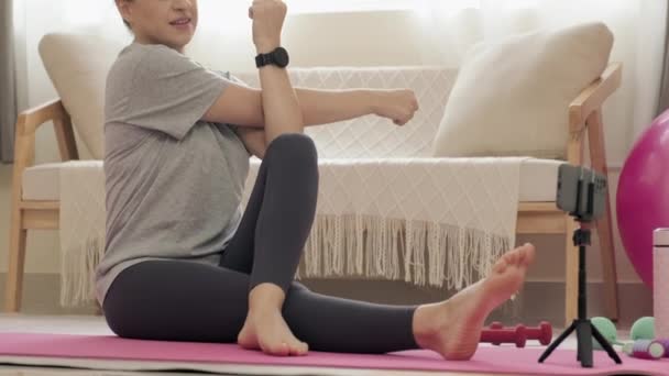 Woman Practicing Yoga Asana Watching Online Class Smartphone Tripod While — Vídeo de Stock