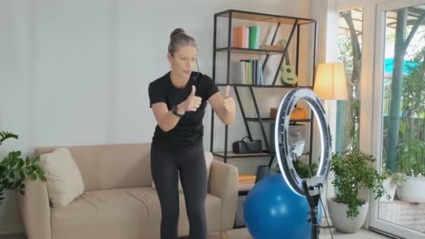 Female Fitness Trainer Using Ring Light Smartphone While Filming Video — Stockvideo