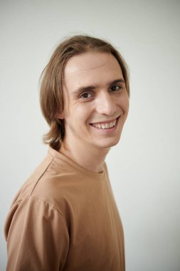 Portrait of positive young man smiling at camera