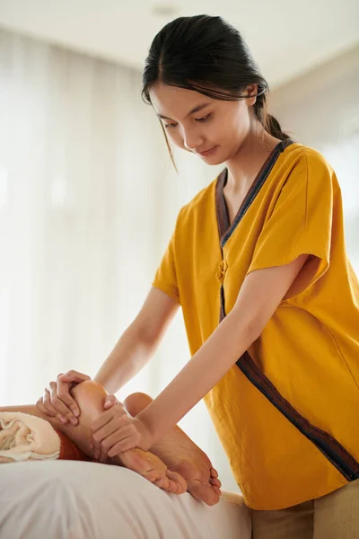 Young Masseuse Giving Relaxing Feet Massage Woman Creams Oils — Zdjęcie stockowe