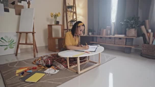Young Black Woman Drawing Picture Table While Sitting Floor Wine — Vídeo de Stock