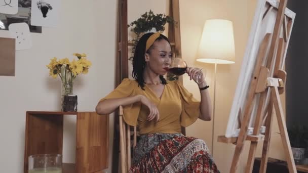 Young African American Woman Sitting Chair Living Room Drinking Red — Stock videók