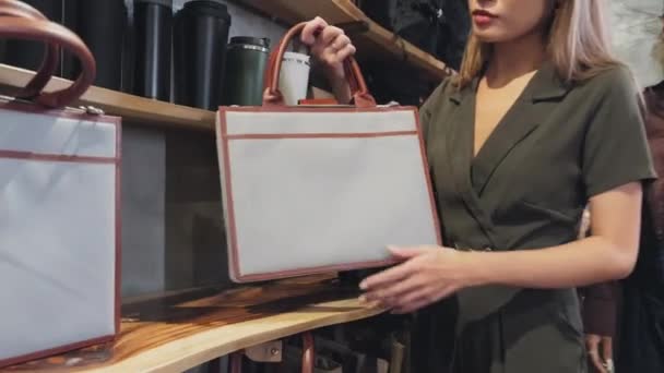 Zoom Out Shot Young Asian Woman Choosing Bag Fashion Store — Stockvideo