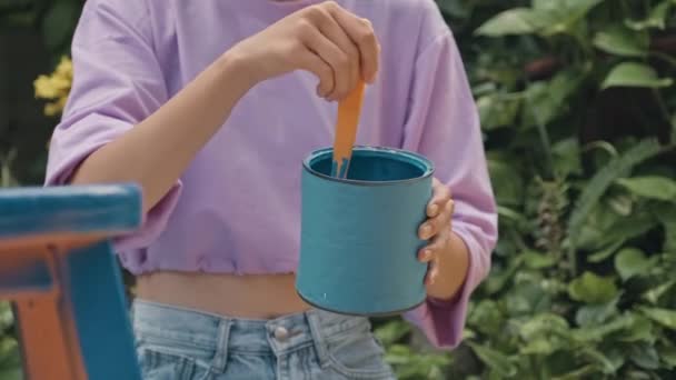 Cropped Impersonal Shot Girl Stirring Blue Paint Can Paintbrush While — Stock video
