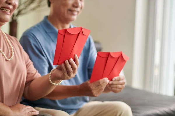 Red Envelopes Tet Celebration Hands Senior Couple — Stockfoto