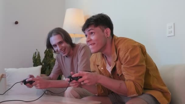 Two Young Male Friends Using Controllers While Playing Video Games — Αρχείο Βίντεο