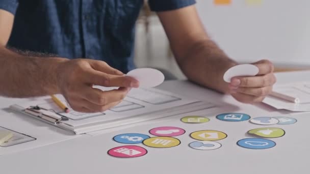 Cropped Shot Designer Examining Icons Taking Notes Layout Sketches While — Vídeo de Stock