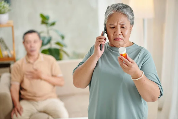 Worried Senior Woman Calling Doctor Ask She Can Giving Pills — Fotografia de Stock