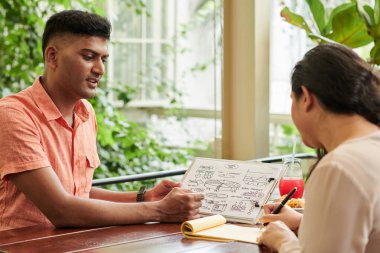 Businessman explaining his ideas to colleagues at meeting
