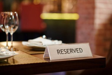 Reserved table sign on restaurant table, booking concept
