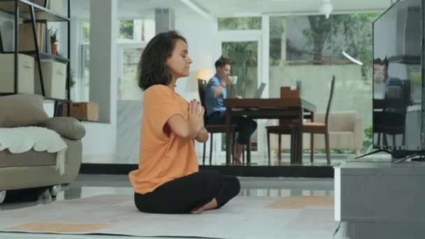 Young Caucasian Woman Practicing Yoga Meditation Home Sitting Lotus Pose — 图库视频影像