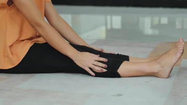 Young Relaxed Brunette Woman Sportswear Stretching Her Back While Sitting — Video Stock