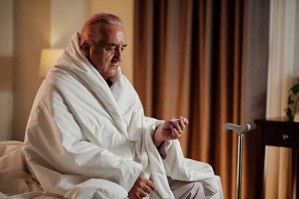 Sick Elderly Man Sitting Bed Wrapped Blanket Checking His Body — Photo