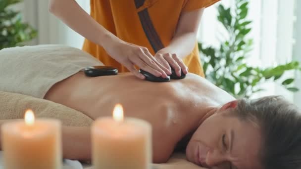Young Caucasian Woman Relaxing Back Massage Stones Luxury Massage Spa — Wideo stockowe