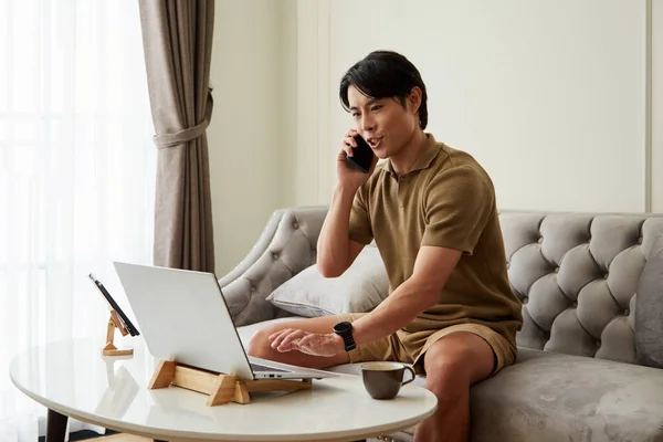 Young Man Working Home Answering Phone Call Client — Stockfoto