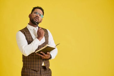 Portrait of pensive entrepreneur filling planner