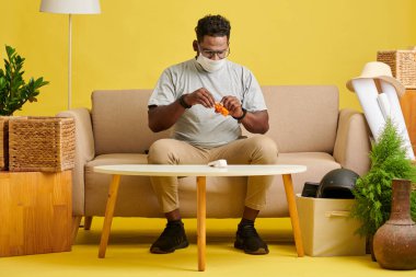 Sick man in medical mask taking pills