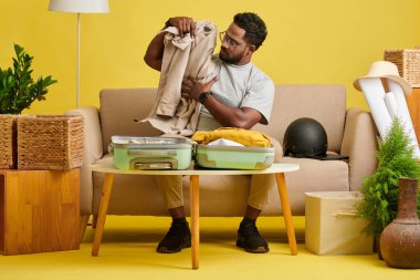 Man packing clothes in suitcase when leaving for vacation