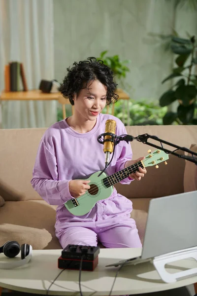 Joyful Teenage Girl Streaming Herself Singing Song Playing Ukulele — Stockfoto