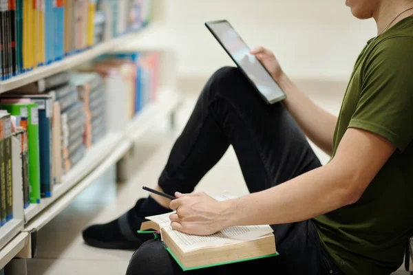College Student Sitting Library Floor Reading Book Taking Notes Tablet — Stok fotoğraf