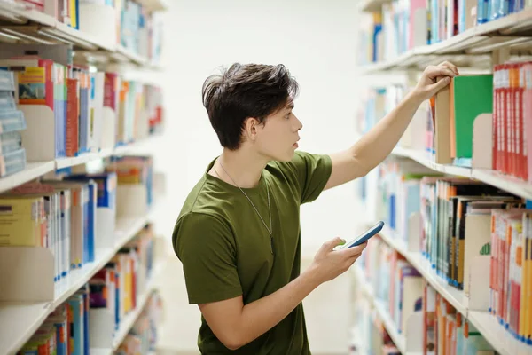 Teenage Boy Looking Book School Library — Stok fotoğraf