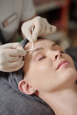 Young woman getting pore cleaning procedure in spa salon