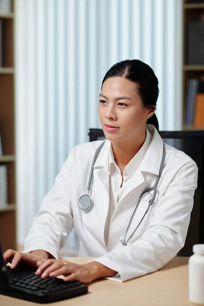 Young Confident Female Teledoc Lab Coat Typing Computer Keyboard While — Stock Photo, Image