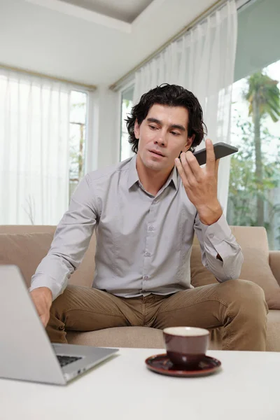 Akıllı Telefonlu Kendine Güvenen Genç Adam Hoparlörden Konuşuyor Yerindeki Kanepesinde — Stok fotoğraf
