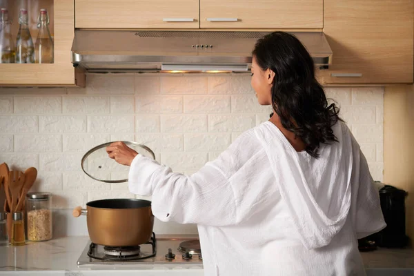 Young Woman Loungewear Opening Lid Saucepan Cooking Kitchen View Back — Stock Photo, Image