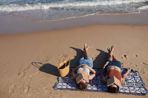 Freundinnen Sonnen Sich Strand Mit Aufgeschlagenen Büchern Die Gesichter Bedecken — Stockfoto