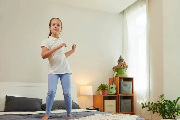 Smiling Preteen Girl Jumping Dancing Bed Alone — Stock Photo, Image
