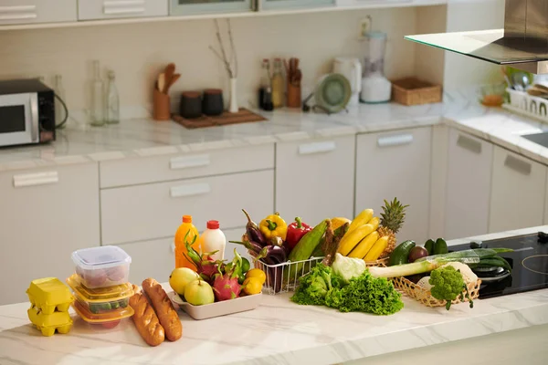 Fresh fruits, vegetables and other groceries on kitchen counter