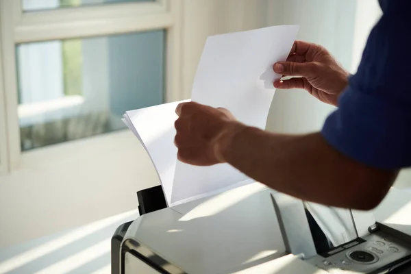 Office worker printing documents for meeting