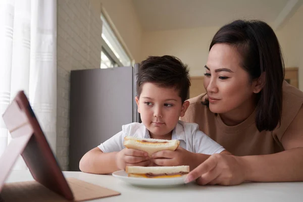 Smiling Mother Giving Sandwiches Little Son Watching Educational Video Tablet — Stock Photo, Image